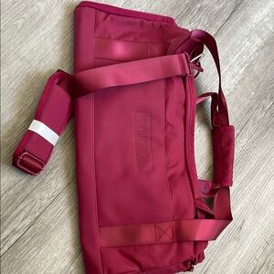 Gymshark Red Travel Bag with Adjustable Straps and Modern Design